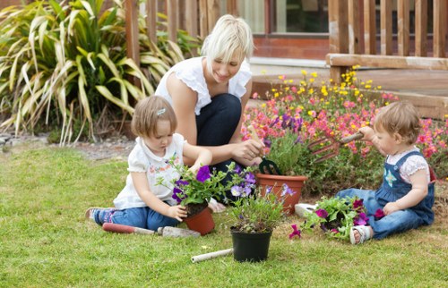 Gardener working in a neighborhood garden representing Plaistow maintenance services